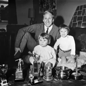 Manchester Uniteds Bobby Charlton shows off his many trophies that he has won to his Manchester Uniteds Bobby Charlton shows off his many trophies that he has won to his