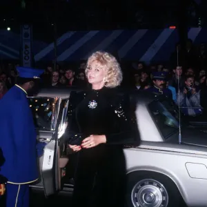 Mandy Rice Davies premiere film Absolute Beginners black dress car door opened by caped Mandy Rice Davies premiere film Absolute Beginners black dress car door opened by caped