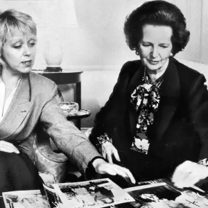 Margaret Thatcher looking over photographs with official - May 1987 Margaret Thatcher looking over photographs with official - May 1987