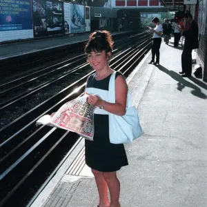 Maria Smedley actress reading copy of Daily Mirror Newspaper while standing Maria Smedley actress reading copy of Daily Mirror Newspaper while standing
