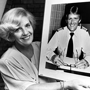 Marie Duffy with a photograph of her husband John who is Hotel Manager of the QE2 which