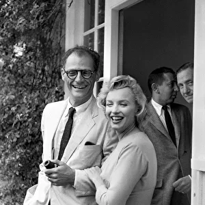 Marilyn Monroe arm in arm with husband Arthur Miller July 1956. smiling