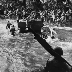 US Marines carrying stretchers splash through the surf after having disembarked from huge US Marines carrying stretchers splash through the surf after having disembarked from huge