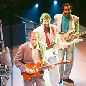 Mark Knopfler, Eric Clapton and another performer on stage at The Prince