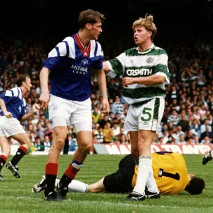 Mark McNally argues with Duncan Ferguson as goalkeeper Pat Bonner lies injured football