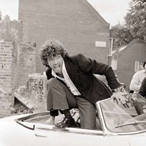 Martin Shaw Jumping out of a white convertable car on the set of The Professionals