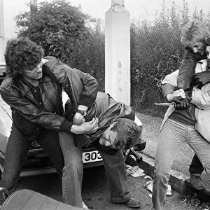 Martin Shaw and Lewis Collins wrestling with the bad guys on the set of the television