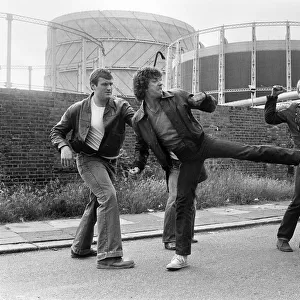 Martin Shaw and Lewis Collins wrestling with the bad guys on the set of the television