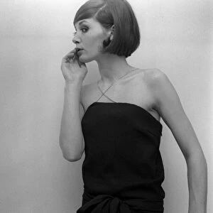 Mary Quant fashion clothing Model looking worried wearing a black dress with cross