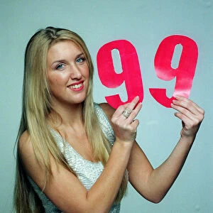 The Max Cover December 1998 Model Erin Gavin holding the number 99