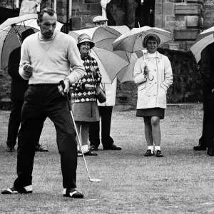 Max Faulkner contemplates his putt at the British Golf Open as spectators keep dry with Max Faulkner contemplates his putt at the British Golf Open as spectators keep dry with