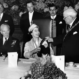 The Mayor of Dudley presents the Queen with a black leather handbag during her visit to The Mayor of Dudley presents the Queen with a black leather handbag during her visit to
