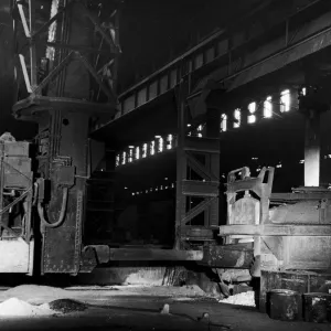 A mechanical charging machine feeding a 30 ton electric arc furnace at the English Steel A mechanical charging machine feeding a 30 ton electric arc furnace at the English Steel