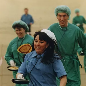 Medical staff take part in a Shrove Tuesday Pancake Race along the North East Coast line