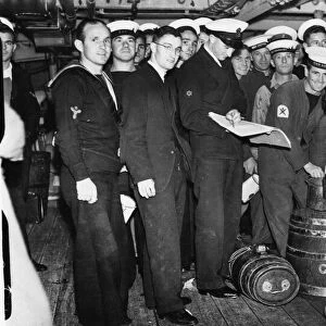 Members of the Ajax crew wait for their daily rum ration shortly after their arrival in