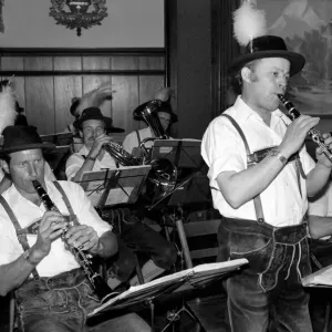 Members of a Bavarian band performing wearing traditional Bavarian dress during a night