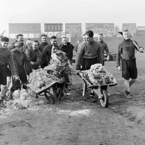 Members of the Fulham football team clearing the snow from their pitch before their FA Members of the Fulham football team clearing the snow from their pitch before their FA