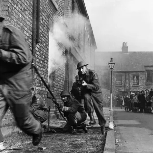Members of the Home Guard running through a training exercise in a residential street in Members of the Home Guard running through a training exercise in a residential street in