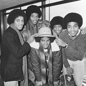 Members of The Jackson Five pop group make their way through the arrivals hall as they