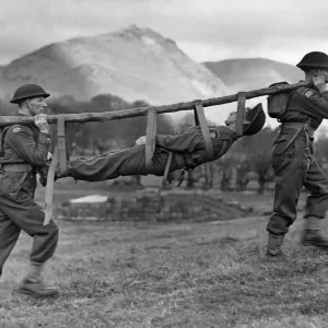 Members of the Royal Army Medical Corps improvise a stretcher for a casualty during a Members of the Royal Army Medical Corps improvise a stretcher for a casualty during a