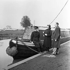 Members of the Salvation Army stand next to their barge. April 1954