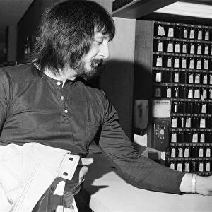 Members of The Who rock group. Bass guitarist John Entwistle hands in his hotel key
