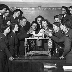 Members of the Womens Auxiliary Air Force being taught to fit the magazine in an