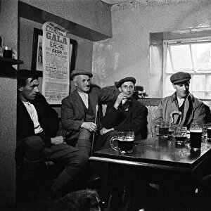 Men enjoying a pint at the Royal Oak Inn, in Braithwaite village near Keswick, Cumbria