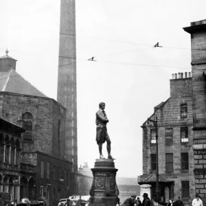 Men gathered around Robert Burns monument where Constitution and Bernard Street meet