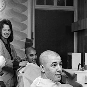 Two men getting "Kojak"hair cuts. 1975
