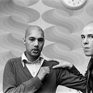 Two men with "Kojak"hair cuts. 1975
