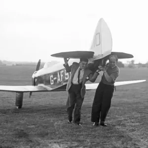 Two men manually transporting a Chilton DW1A across the field at Bagington Circa 1955 Two men manually transporting a Chilton DW1A across the field at Bagington Circa 1955