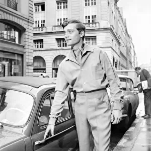 Men modelling the latest 1963 menswear designs in the streets of Paris. April 1963