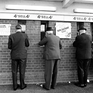 Men placng bets at the tote before a race October 1969
