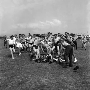 Men play hunt the shoes at a holiday camp print, August 1952 Men play hunt the shoes at a holiday camp print, August 1952