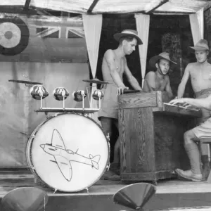 Men of the Royal Air Force spend their lunch time break with a song at the piano in their Men of the Royal Air Force spend their lunch time break with a song at the piano in their