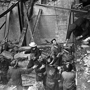 Men working in a building damaged by an Air Raid during the Blitz