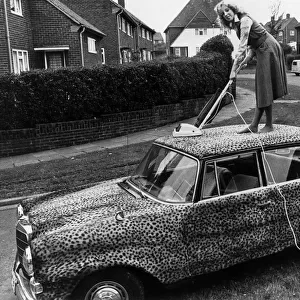 Mercedes car covered in leopard skin being hoovered 1989