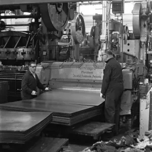 Metal sheets are fed into the body panel press at the The Austin Mini production line Metal sheets are fed into the body panel press at the The Austin Mini production line