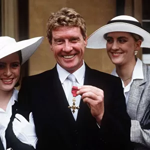 Michael Crawford actor singer receives his MBE from Buckingham Palace with his two