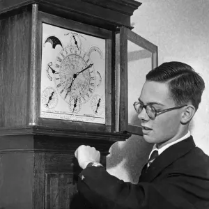 A 1955 print of a boy standing next to his grandfather clock