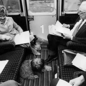 Michael Foot and wife Jill Craigie on train with their dog - May 1983