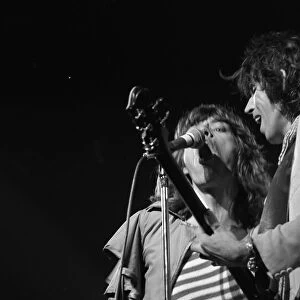 Mick Jagger and guitasrist Bill Wyman performing on stage during a Rolling Stones concert