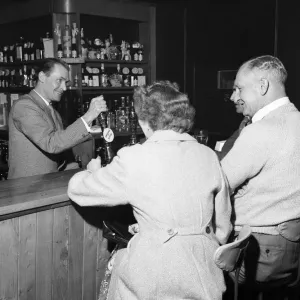 Former Middlesbrough footballer Wilf Mannion serving customers at the bar in his pub Former Middlesbrough footballer Wilf Mannion serving customers at the bar in his pub