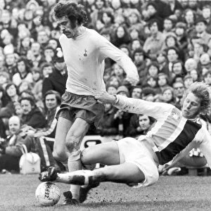 Mike England of Spurs is challenged for the ball by Bobby Bell of Crystal Palace during