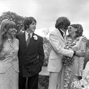 Mike McCartneys Wedding. Mike McGear kisses bride Angela watched by his