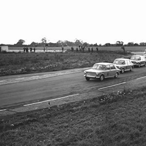 Mike Parkes No 87 leads the competitors in the Molyslip Morris 1100 race at Snetterton