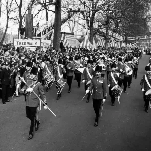 A military band leads the Battersea Easter Parade of 1971 as crowds gather to watch