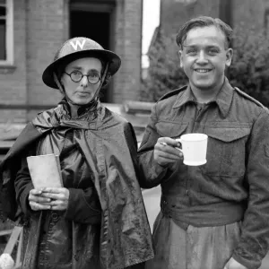Military Personal take a break from inspecting Bomb damage after Air Raid, Solihull