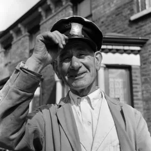 Black and white photograph print of a milkman with housewives